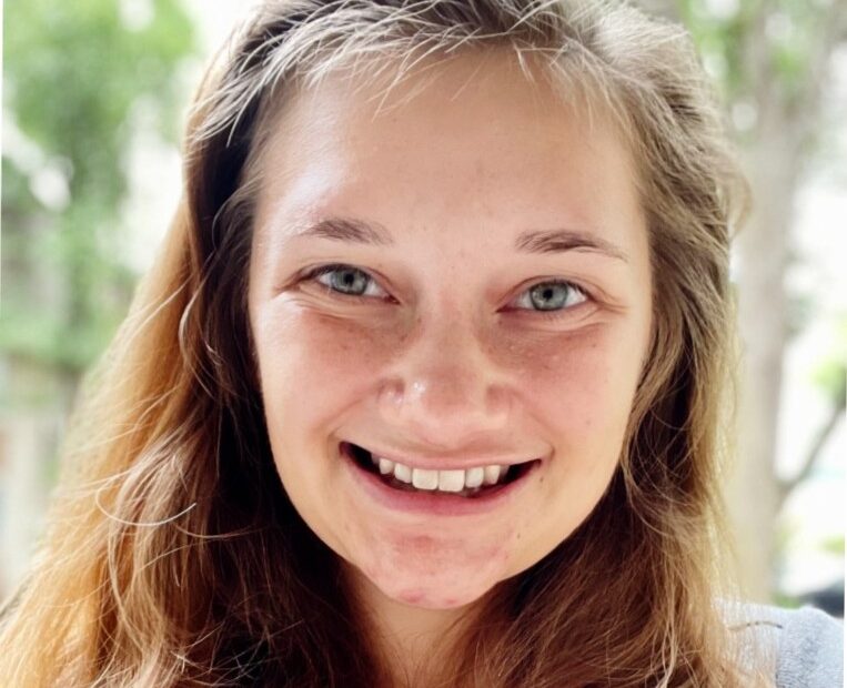Head shot of a smiling white woman with light brown hair